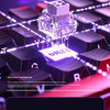 A close-up view of a mechanical keyboard with translucent switches and RGB lighting on a dark surface.