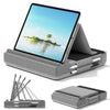 A foldable tablet pillow stand with a screen displaying a tropical scene and an attached stylus holder.
