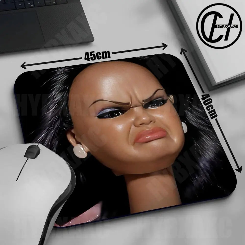 A close-up of a doll face mouse pad featuring a realistic portrait with a rubber non-slip base.