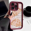 A close-up of a pink phone case with a croissant newspaper pattern featuring the name anna.