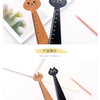 A set of cute cartoon cat wooden drawing rulers in natural wood and black, displayed on white paper.