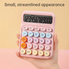A pink 12-digit mechanical calculator with a digital display and round keys is held in a hand.