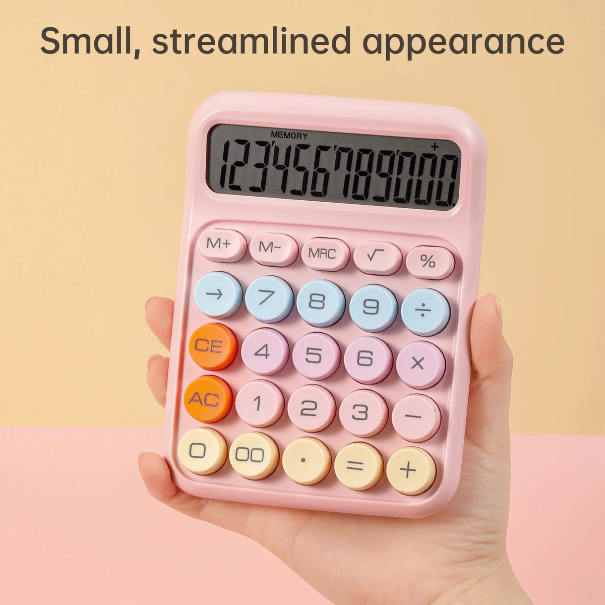 A pink 12-digit mechanical calculator with a digital display and round keys is held in a hand.