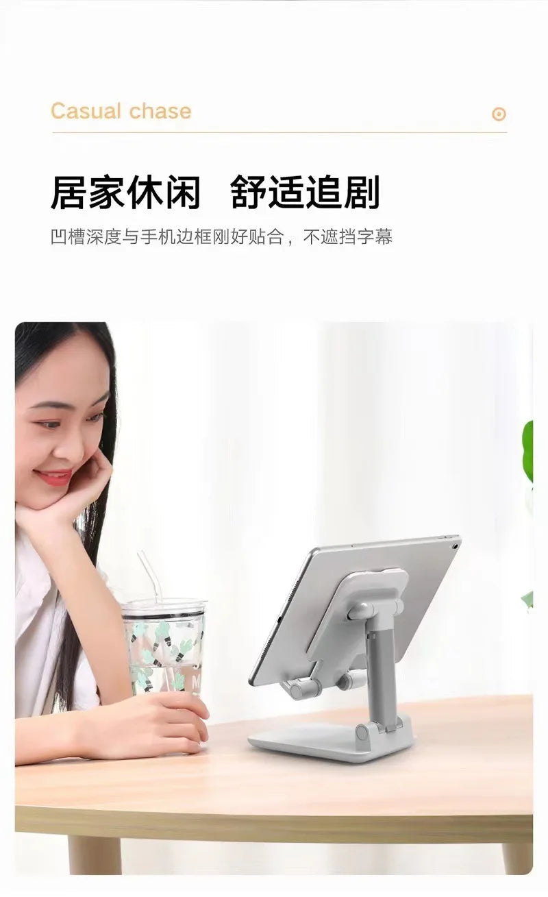 A woman is using a foldable desktop phone stand on a wooden table for casual use.