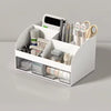 A white multifunctional desk organizer with two clear storage drawers holding pens, scissors, and other office supplies.