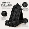 A black gothic arch design phone stand featuring intricate dark details and skull accents.