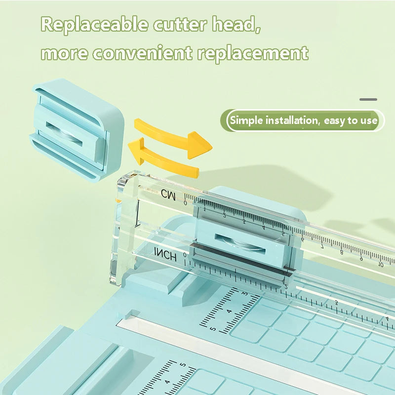 A close-up view of a manual paper cutter with an interchangeable blade, showing the replacement mechanism and cutting surface