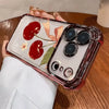 A clear iPhone case with a cherry blossom pattern and an electroplated finish is held in a hand.