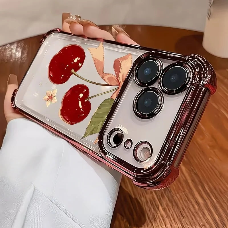 A clear iPhone case with a cherry blossom pattern and an electroplated finish is held in a hand.