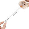 A hand is attaching a acrylic badge reel to a hamster, showing the size of the clip.