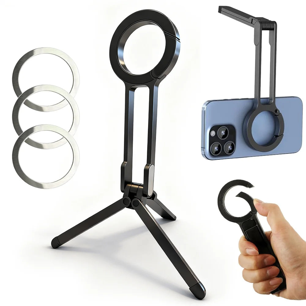 A black magnetic phone tripod stand with a carabiner attached, shown next to multiple metal rings and a smartphone.