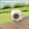 A white mini fan with a digital display and battery indicator is placed on a wooden surface outdoors.