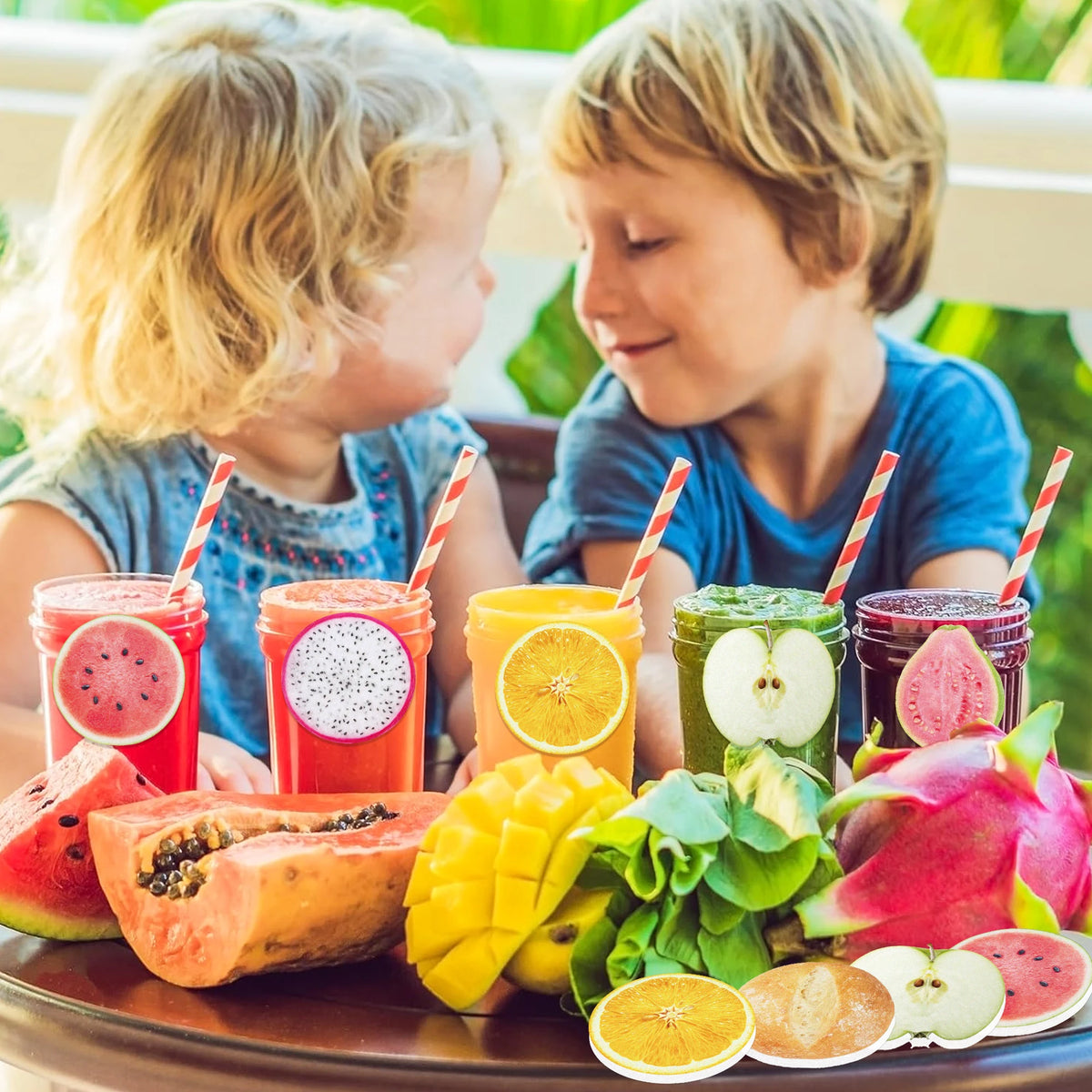 Children holding fruit-shaped sticky notes and fresh fruit on a wooden surface