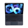 A silver backlit magic keyboard case for an iPad showing a colorful logo on the screen.