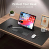 A laptop is placed on a black desk mat with a mouse and a coffee cup, demonstrating a large PU leather desk mat for laptop an