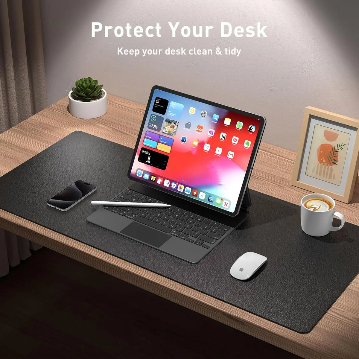 A laptop is placed on a black desk mat with a mouse and a coffee cup, demonstrating a large PU leather desk mat for laptop an