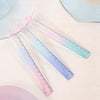 Three transparent plastic rulers shaped like cat paws display a gradient of pink and blue colors.