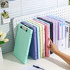 A collection of colorful A4 document and photo storage file boxes lined up on a white desk.