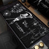A black mouse pad featuring a white illustration of a figure with a sword and a dark angel design.