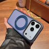 A hand holds a purple magnetic phone case with a rotating ring and multiple camera lenses on a wooden surface.