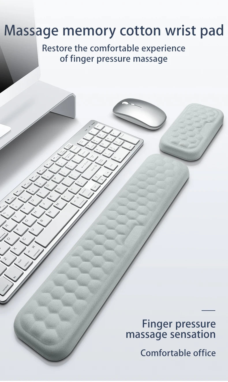 A light gray massage memory cotton wrist pad is shown next to a computer keyboard and mouse for finger pressure massage.