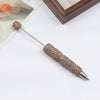 A silver pen accessory featuring a gold-colored beaded tip and a decorative top, displayed on a white surface.