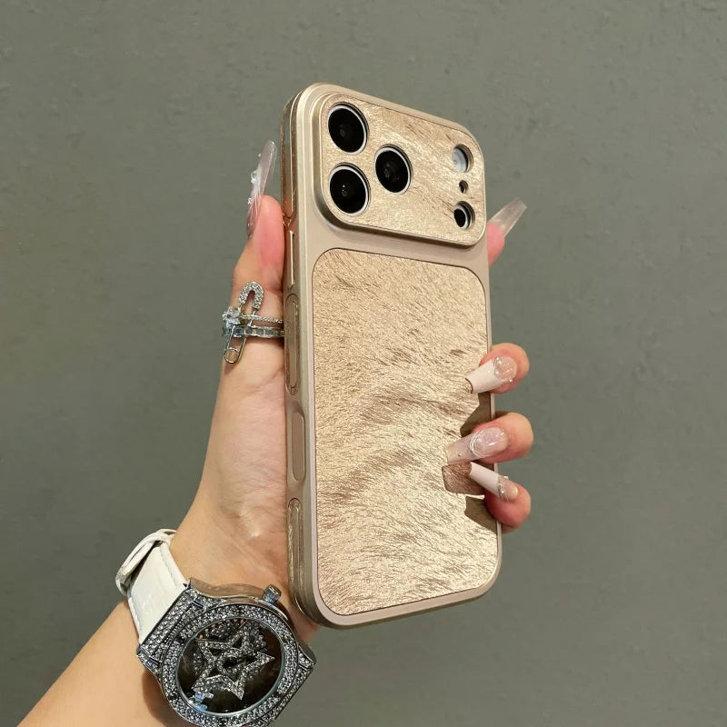 A hand holds a luxury frosted velvet texture phone case with shockproof protection in a beige color.