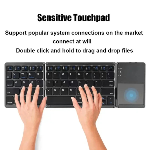 A person is using a folding Bluetooth keyboard with a touchpad to drag and drop files on a laptop.