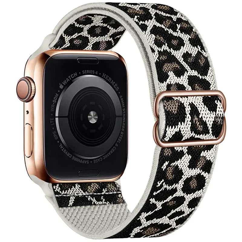 A close-up of an Apple Watch with a leopard print nylon band and a rose gold case.