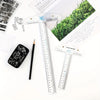 A set of acrylic T-square rulers, including 6 inch and 12 inch versions, are displayed on a white surface next to a pen and p