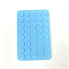 A blue silicone phone mount grip with multiple circular holes for mounting devices.