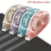 Five random colored double-sided adhesive tape rollers lined up on a dark surface.
