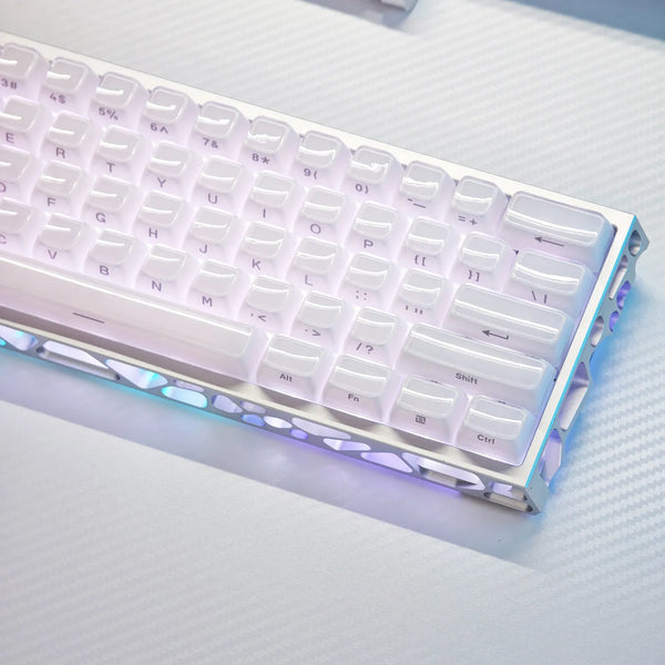 A close-up of a white mechanical keyboard with translucent purple and blue ice crystal keycaps illuminated by RGB lighting.