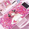 A pink anime character design printed on a large pink and magenta rubber mouse pad and desk mat.