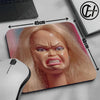 A realistic doll face design printed on a mouse pad with measurements indicating its size.
