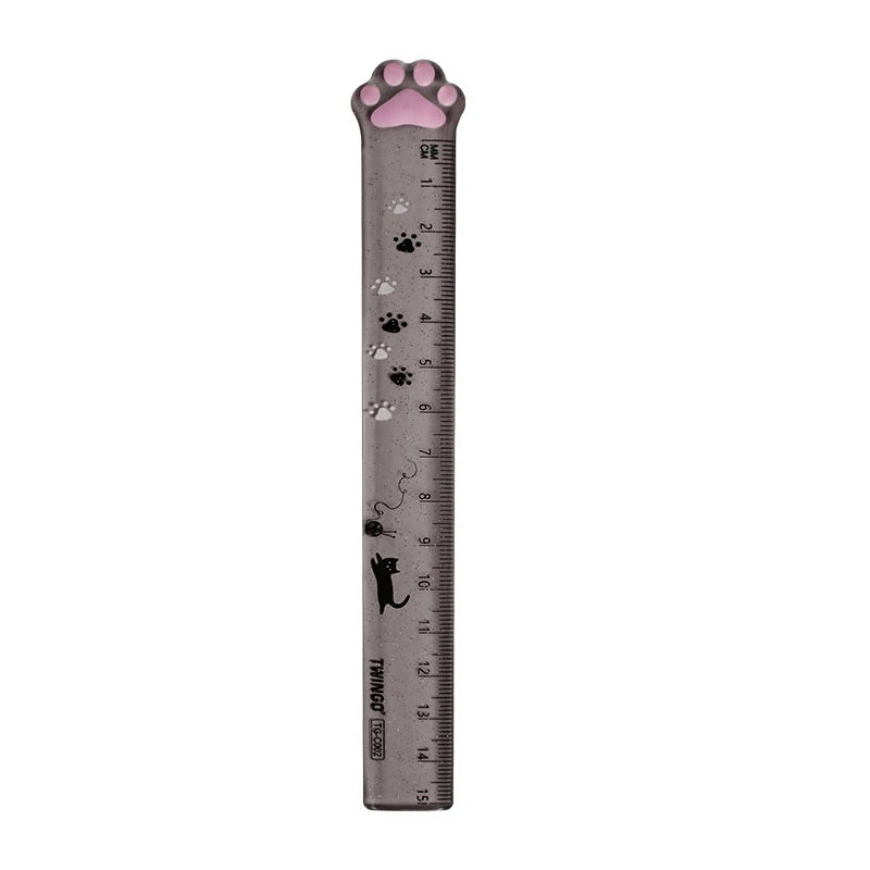 A gray plastic straight ruler marked with paw prints and measurements, showing a cat paw shape.