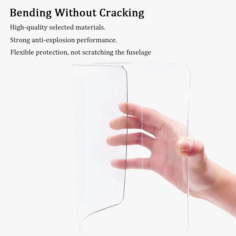 A hand is holding a clear, flexible hard shell laptop case with a keyboard cover and screen protector.