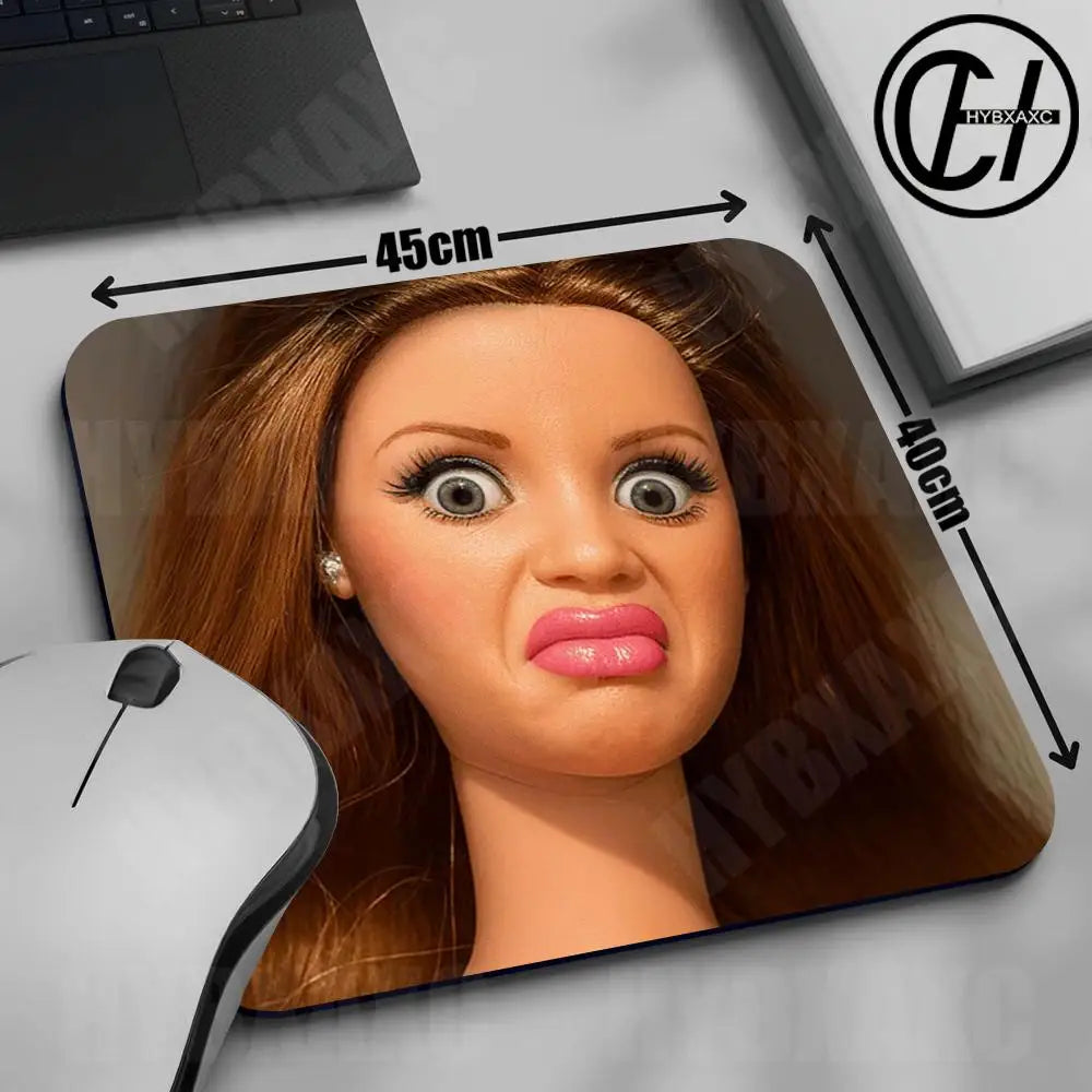 A close-up of a cute doll face mouse pad with a non-slip rubber base, showing measurements and the product design.