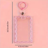 A clear pink acrylic card holder with a pink key ring and a metal loop, shown against a light pink background.