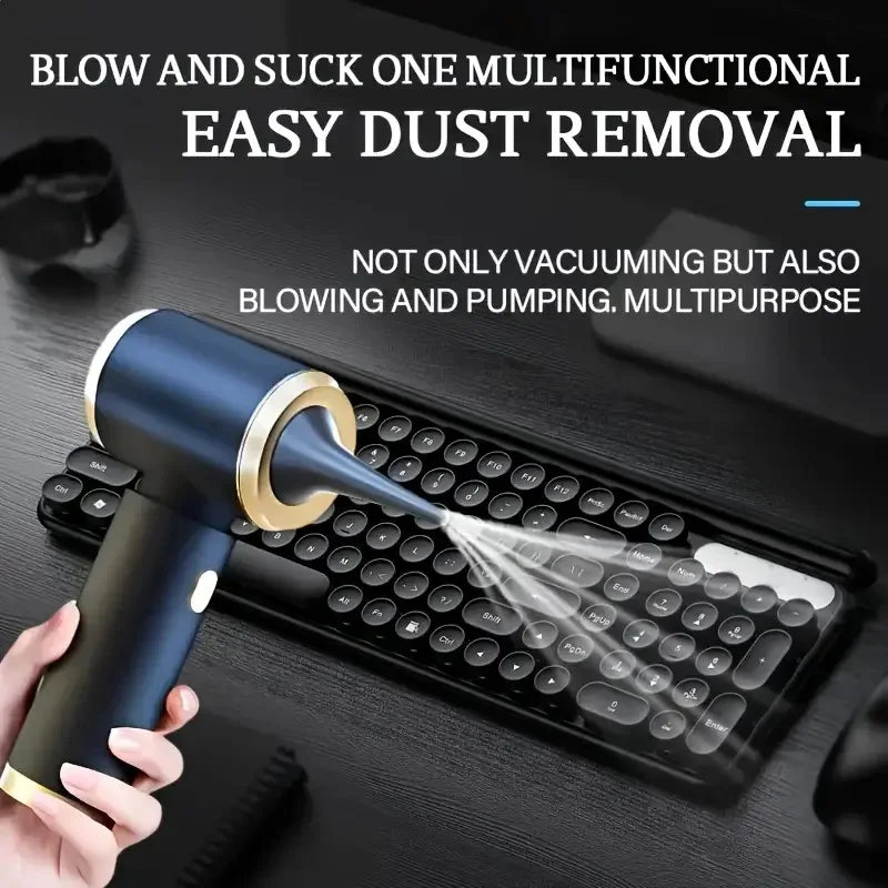 A hand is using a blue and gold multifunctional tool to blow and suck dust from a laptop keyboard.