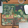 A large green kawaii frog desk mat featuring various potted plants and a wooden ladder.