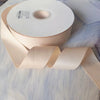 Roll of matte finish satin ribbon in a pale blush pink color