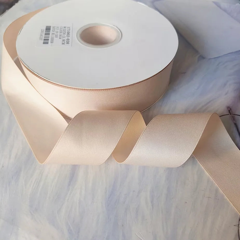Roll of matte finish satin ribbon in a pale blush pink color