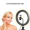 A woman is using a live supplementary lamp LED ring light with a tripod stand for makeup or photography.