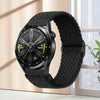 A black nylon watch strap with a digital watch face is displayed next to a window.