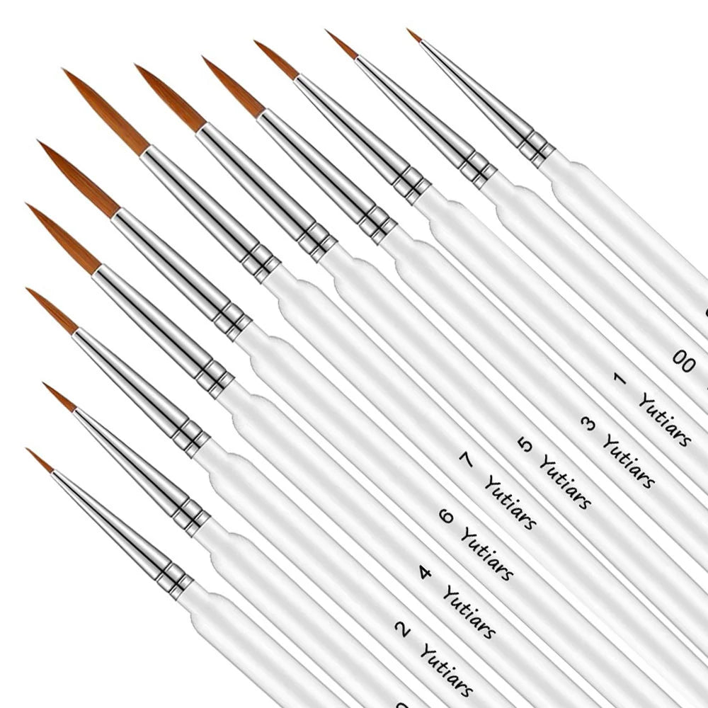 A set of professional miniature paint brushes with ergonomic handles, showing various sizes and tips.