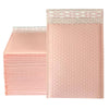 A stack of pink padded bubble mailers with self-seal closures is shown.