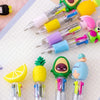 A collection of cute cartoon mini ballpoint pens in various colors including yellow, green, pink, and blue.