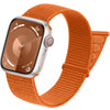 An orange Apple Watch with a matching sport hook and loop strap shown from the side.
