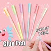 A collection of colorful glue pens in various shades including yellow, pink, and blue, shown being held by a hand.